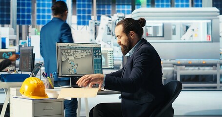 Solar panel manufacturing plant researcher taking notes while developing new solar energy systems...