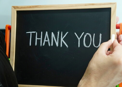 A close-up shot of a small chalkboard with the word "THANK YOU" written on it in white chalk, thank you yo our sponsors word or text isolated on white background, thank you, thank you for your order