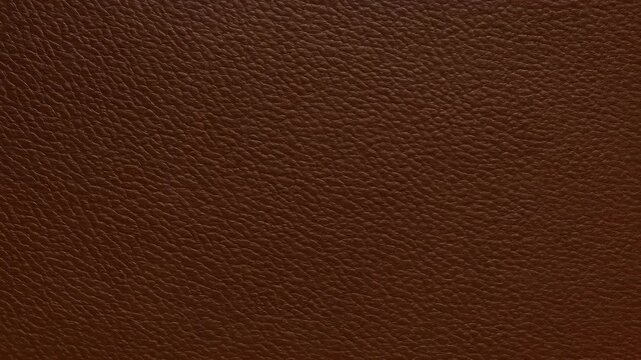Close-up of textured brown leather with an Adobe Stock watermark.