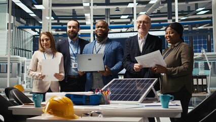 Management executives talk about automation strategies for solar panel production scaling. Businesspeople in factory doing financial investments in eco friendly energy manufacturing sector, camera A