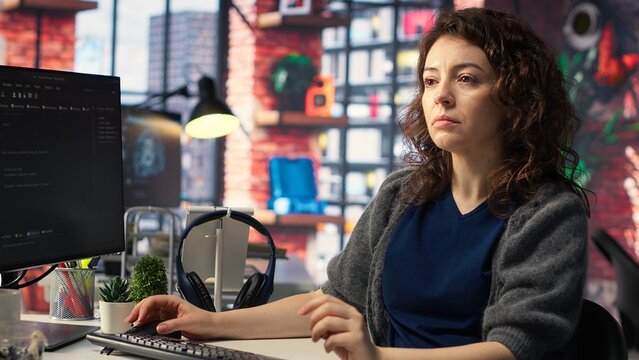 IT expert writing code and debugging on artificial intelligence neural networks computerized brain model. Woman tech support doing checkup on AI systems, cloud computing. Camera B.