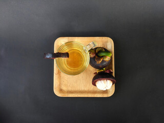 mangosteen fruit (Garcinia mangostana) served with a drink made from its peel extract