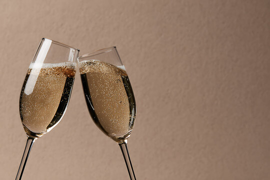 party celebrations, champagne glasses clinking in a glittery backdrop, setting a celebratory tone