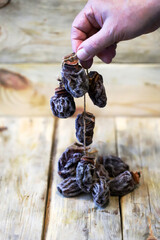 Close-up of hands holding dried persimmons, or hoshigaki.