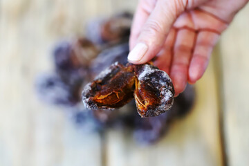 Close-up of hands holding dried persimmons, or hoshigaki.