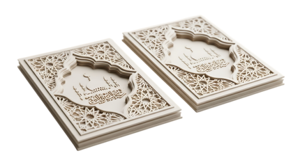 Two intricately carved white Islamic books with mosque silhouettes and Arabic script, cutout, PNG isolated on white or transparent background