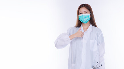 Asian female doctor wearing medical face mask and lab coat showing thumbs up gesture. Professional scientist portrait isolated on white background for healthcare concept with copy space.