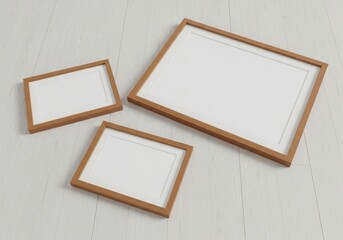 Fototapeta premium Three empty wooden picture frames on a clean light wood floor