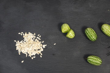 Cucamelon fruits with seeds on slate background