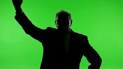 Silhouette of a man waving on a green screen, perfect for compositing.