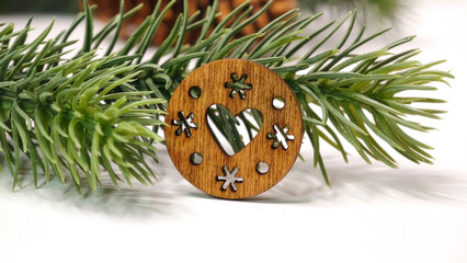 Wooden Heart Ornament with Stars in Pine Branches on White Holiday Background
