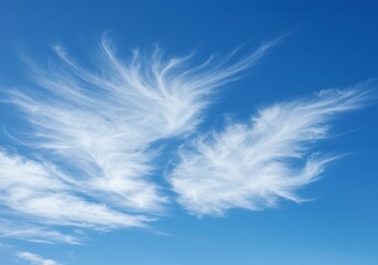 Wispy clouds against vibrant blue sky background suggesting freedom and nature