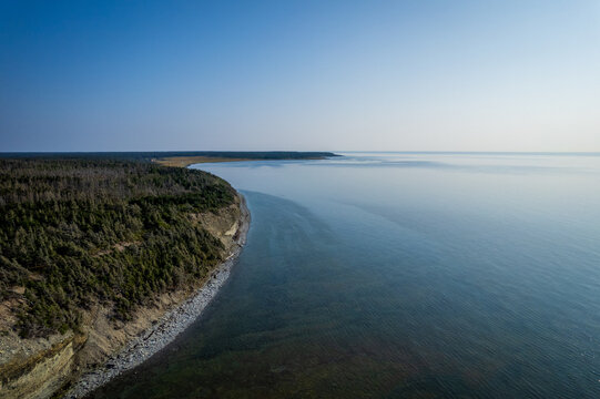 Coastal Cliff, Layered Rock Formations and Boreal Forest at English Head on a Sunny Day in Anticosti, Quebec, Canda