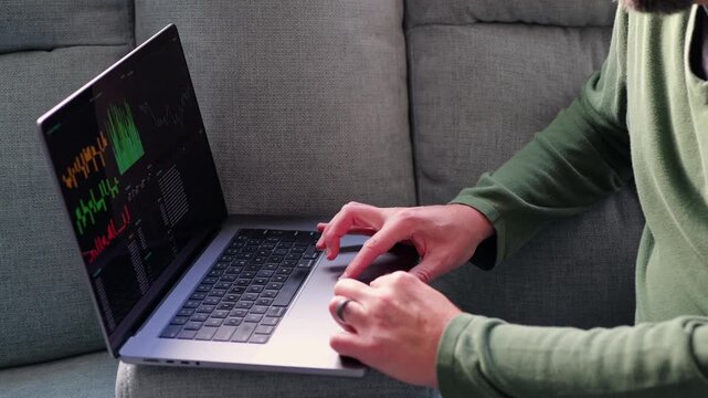 Middle Aged Day Trader Moving Around Downstairs of Home While Working Daily Trades on Stock Market Concept