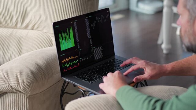 Middle Aged Day Trader Moving Around Downstairs of Home While Working Daily Trades on Stock Market Concept