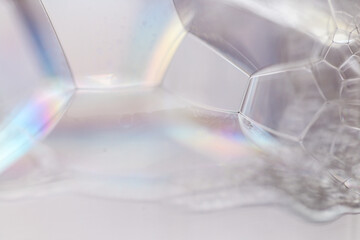 close-up geometric foam with prism reflections, faceted bubble walls create crystalline structure, soft pastel highlights and sterile minimal backdrop, ideal for science or optics visuals