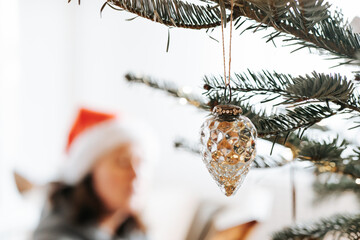 Christmas and New Years books.Winter cozy reading. girl in a Santa hat reads a book in a cozy room, with a Christmas tree and festive decorations in the foreground.Christmas tales, stories, myths