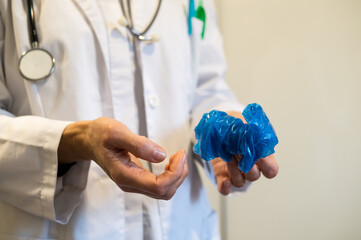 Doctor demonstrating how to safely remove gloves to avoid infection
