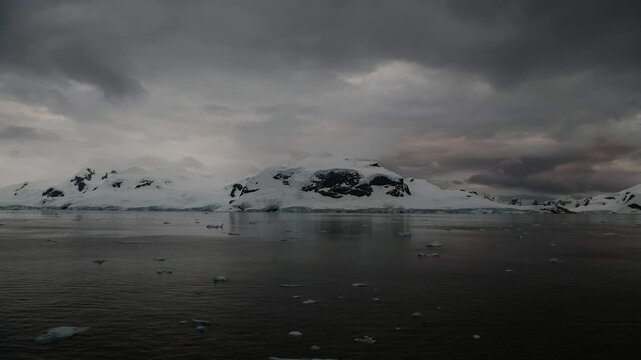 Stunning sunset over icy waters with floating icebergs in Antarctioca