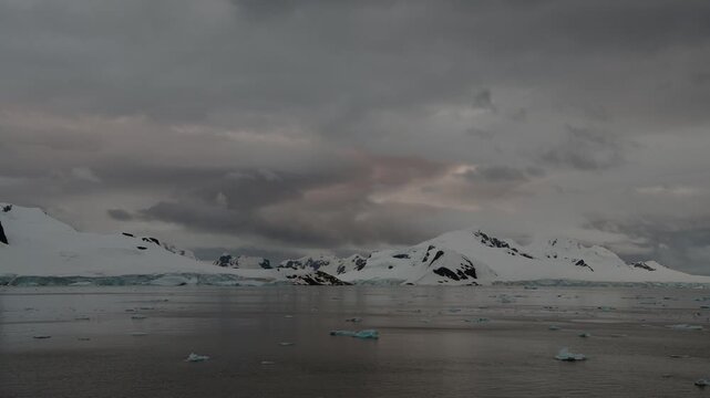 Stunning sunset over icy waters with floating icebergs in Antarctioca