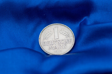 High Quality Macro of a Deutsche Mark Coin on Blue Background to sho Germany in the European Union. High quality photo