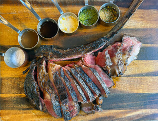 Tomahawk steak, the delicious grilled meat  dishes on the barbecue grill showcase a savory dinner...