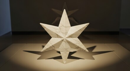 White marble star with seven points casting a shadow on a neutral surface indoors.