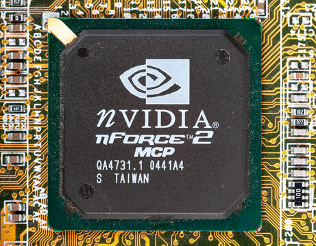 Old dusty NVIDIA nForce 2 MCP chipset on a computer motherboard macro detail extreme closeup, top view. Vintage retro semiconductor electronics technology, PC hardware history, made in Taiwan, object