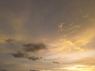 Warm glowing sunset sky with soft textured clouds and subtle color gradients. Peaceful atmospheric view perfect for background and nature visuals.