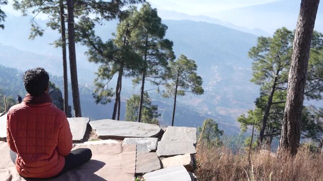 Person Meditating on Kasar Devi Rock in Almora, Uttarakhand Over Himalayan Valley, 4K Footage