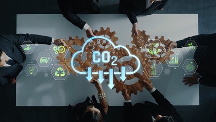 A diverse business team collaborates around a modern conference table, focusing on innovative strategies to reduce carbon emissions and promote sustainability. Raster