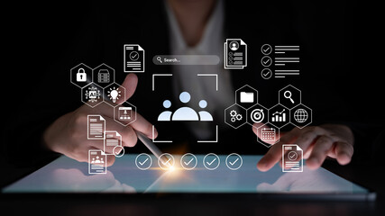 A close-up view of hands interacting with a digital interface on a tablet, showcasing icons related to data management and security in a modern workspace. Gantry