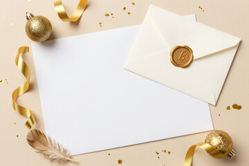 Elegant blank card and sealed envelope with festive golden decorations, ideal for holiday greetings, wedding invitations, or special occasion announcements and messages