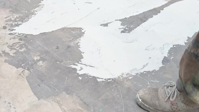 operaio al lavoto con spatola e cemento in un cantiere