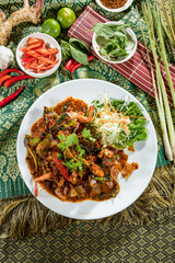 Thai-style stir-fried shrimp with vegetables and herbs, served with shredded cabbage and lettuce.