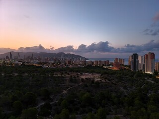 coastal city sunset, dusk over seaside metropolis, sunset skyline above seaside cityscape