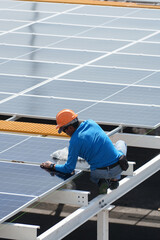 Technicians are installing outdoor solar panel systems. Solar rooftop installation. Solar panels on the roof. Workers are installing energy-saving solar power generation systems.