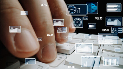 A finger on a keyboard illustrates user interaction with data visualization tools, highlighting digital graphs and metrics in a modern workspace setting. Xenic