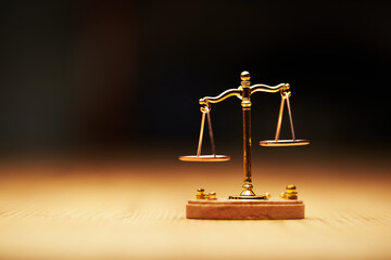 small libra scale on the wooden table.