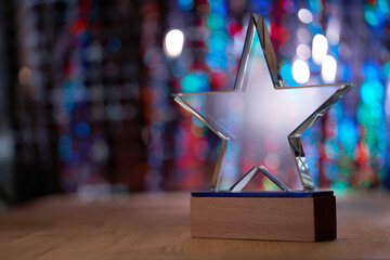 crystal star shape trophy against bokeh light as background
