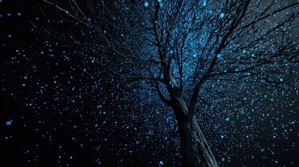 A glowing tree illuminated by blue lights against a dark background, creating a magical and ethereal atmosphere.