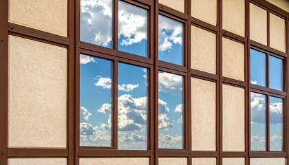 Building Facade with Reflections of Blue Sky and White Clouds Keywords: building, facade