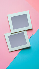 Empty photo frames on a colorful pastel background in a flat lay style