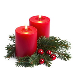 Two red candles with lit flames and green pine branches with red berries.