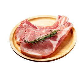 raw pork chops on a wooden plate 