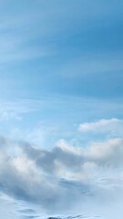 Obraz premium Soft winter sky background with pale gradient and gentle drifting snow mist creating large clean upper copyspace without text
