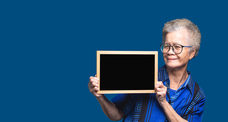 Elderly woman showing blank sign board.