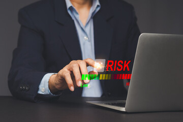 Businessman adjusting virtual risk level indicator.