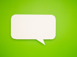 White speech bubble on green background.