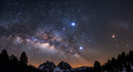 Stunning milky way over snowy mountains and dark silhouette trees in the night